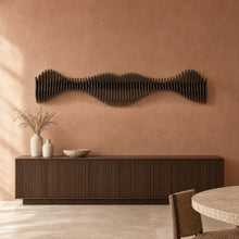 Anomaly II in black stain above a fluted dark-oak sideboard in a terracotta plaster dining room