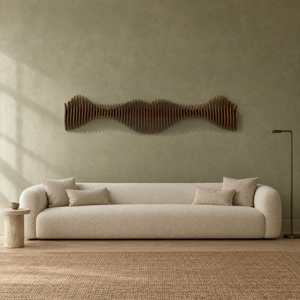 Anomaly II in walnut stain above a cream bouclé sofa in a sage plaster living room