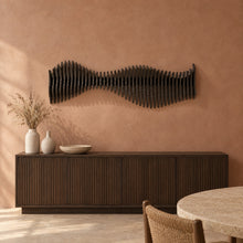 Anomaly in black stain above a fluted dark-oak sideboard in a terracotta plaster dining room
