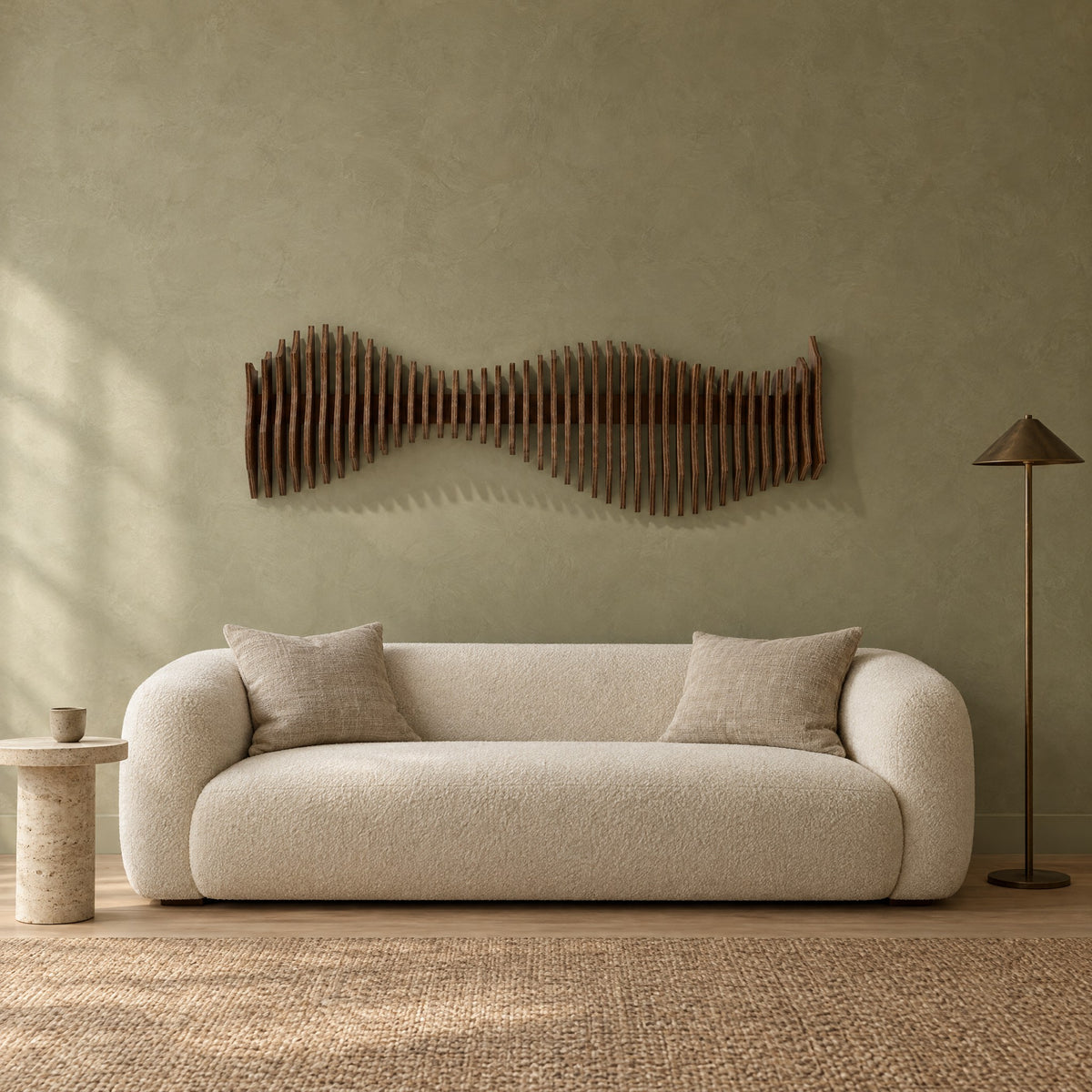 Anomaly in walnut stain above a cream bouclé sofa in a sage plaster living room