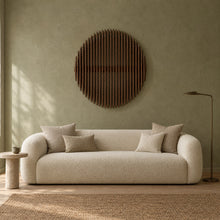 Eclipse in walnut stain above a cream bouclé sofa in a sage plaster living room