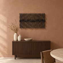 Equinox in black stain above a fluted dark-oak sideboard in a terracotta plaster dining room