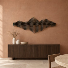 Liminal in black stain above a fluted dark-oak sideboard in a terracotta plaster dining room