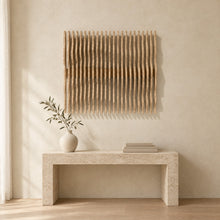 Nami in natural birch above a travertine console in an ivory limewash living room