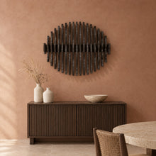 Orbit in black stain above a fluted dark-oak sideboard in a terracotta plaster dining room