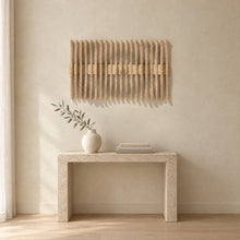 Resonance in natural birch above a travertine console in an ivory limewash living room