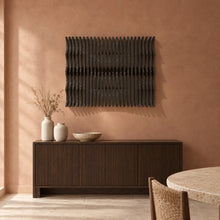 Strata in black stain above a fluted dark-oak sideboard in a terracotta plaster dining room